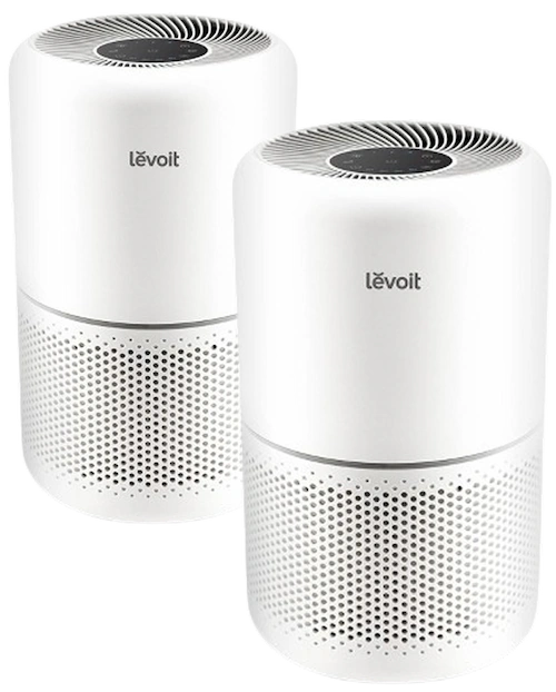 Two Levoit Core air purifiers, one slightly in front of the other. They are small white air purifiers.